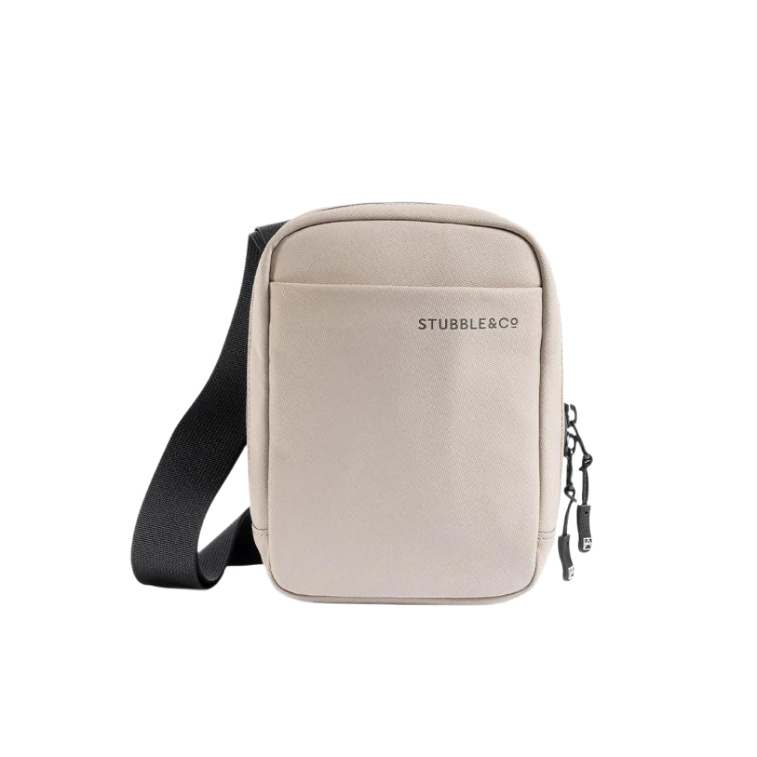 Sand waterproof shoulder bag front view with black strap, zip closure, Stubble&Co branding