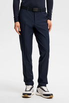 Navy dress pants with belt loops, pleated front, and tapered legs
