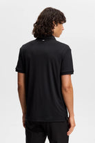 Black polo shirt, back view with short sleeves and collar