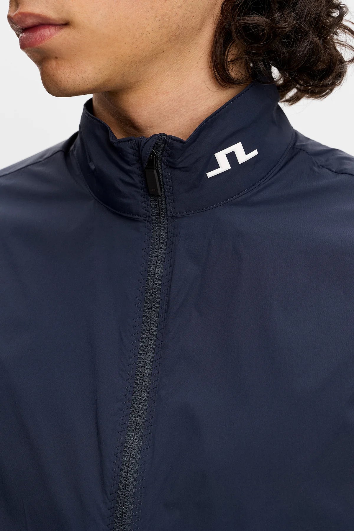 Navy zip-up vest with stand collar and J.Lindeberg logo on chest