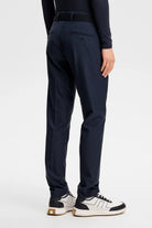 Navy pleated-front pants with belt loops and zip fly; straight tapered fit