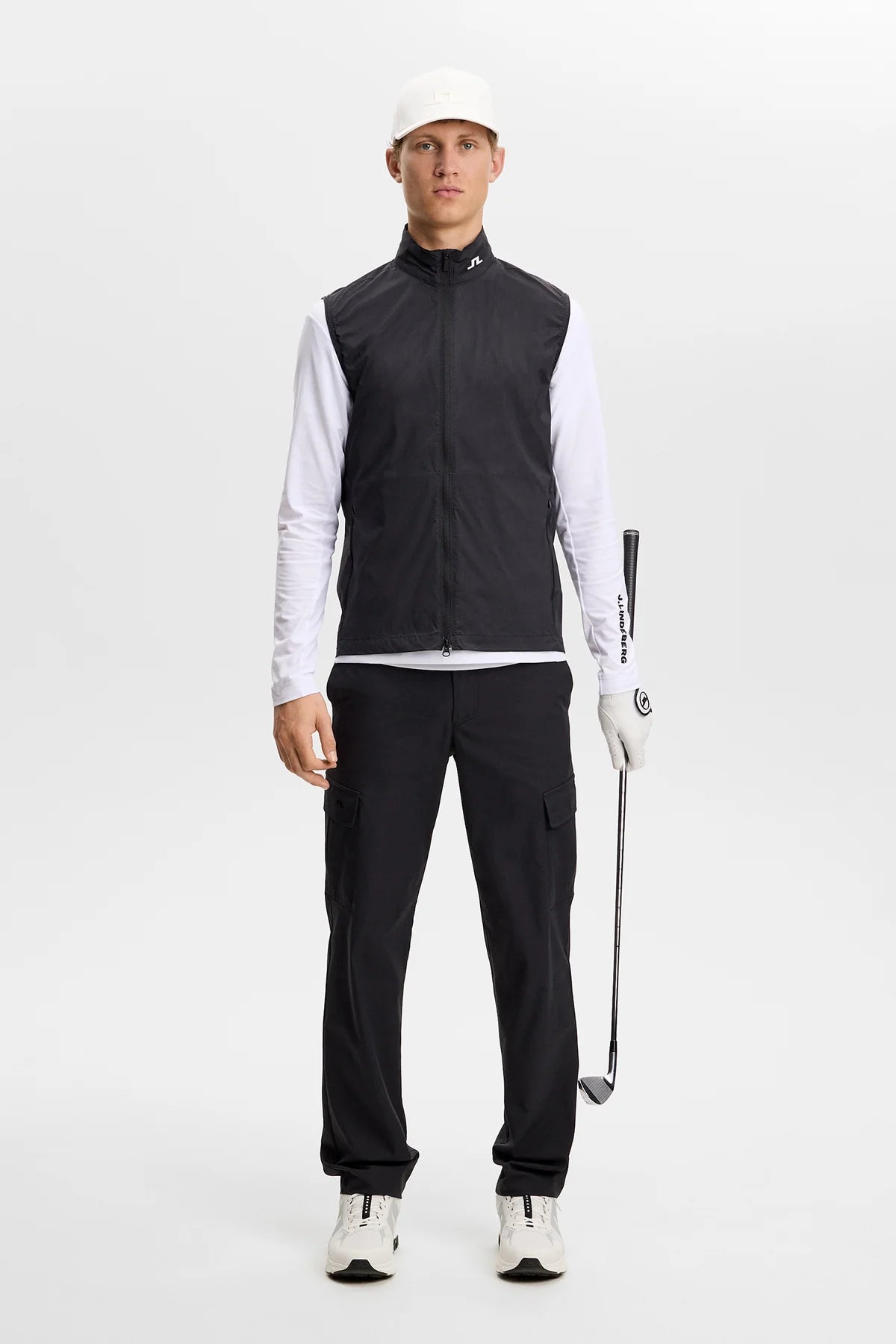 Black packable vest with stand collar and full front zipper, worn by model.