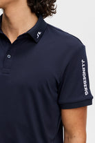 Men's navy polo shirt with collar and J.Lindeberg sleeve lettering