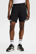 Black shorts with elastic waistband and diagonal striped hem detail on sides