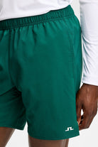 Preston shorts in dark green with elastic waistband and small logo on lower right