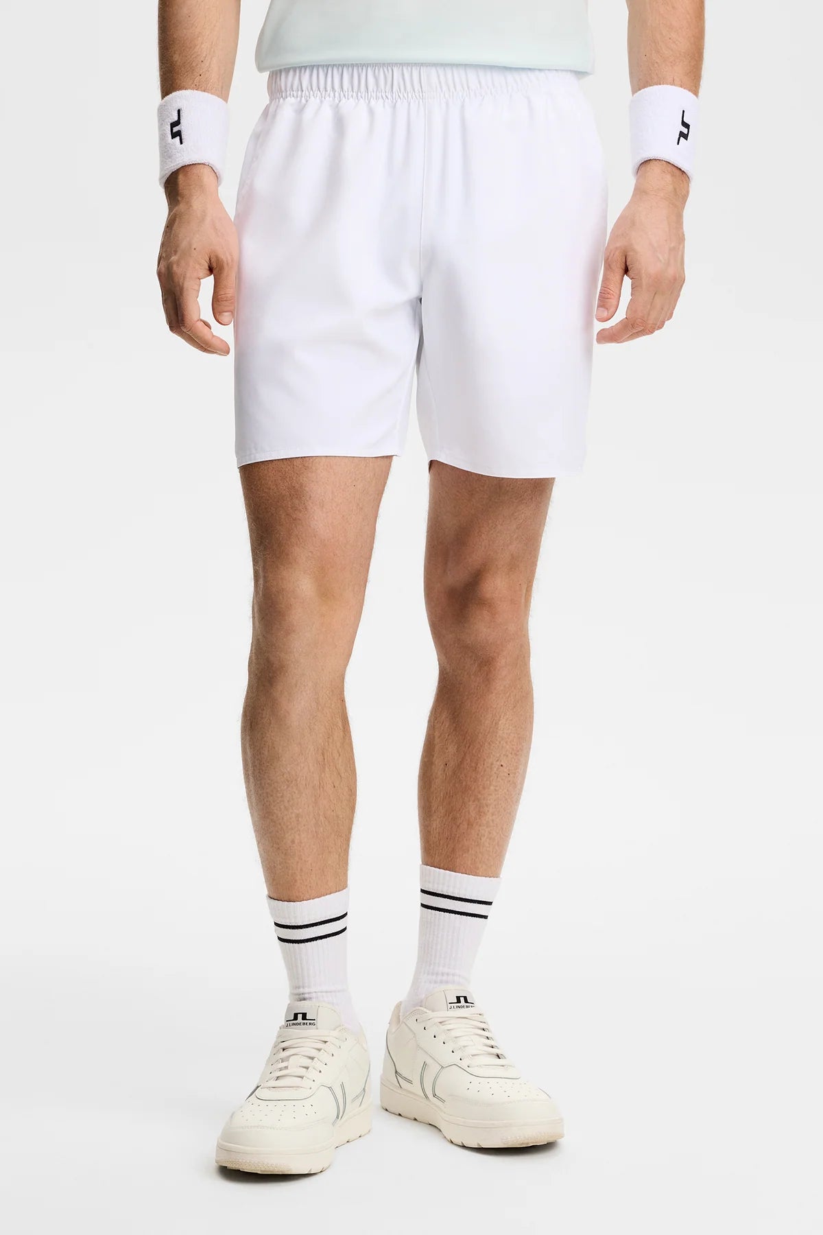 White pull-on shorts with elastic waist, mid-thigh length and side seam.