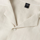 Light sand linen-cotton shirt with open collar, white button placket, neck label
