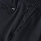 Linen-cotton shorts close-up: brand tag, drawstring, and side pocket seam