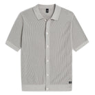Stone grey knit polo shirt with short sleeves, button placket, and contrast collar