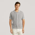 Stone grey knit polo shirt with short sleeves and full button placket