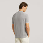Stone grey knit polo shirt back view with ribbed hem and short sleeves