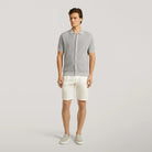 Stone grey knit polo shirt on model, short sleeves and button front