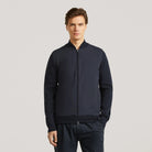 Hybrid bomber jacket on model, full-zip front with ribbed collar, dark navy
