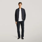 Hybrid bomber jacket on model front, full-zip style over white tee, dark navy