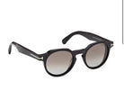 Shiny black round sunglasses angled front view, tinted lenses, logo on temple