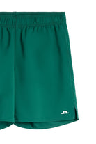 Dark green Preston shorts close-up of elastic waistband and small logo on hem