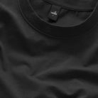 Black crew-neck T-shirt neckline close-up with small logo tag