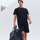 Black crew-neck stretch T-shirt on model, short sleeves