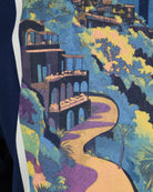 T-shirt close-up of multicolor beach and buildings graphic print.