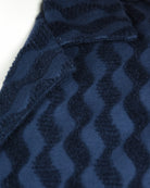 Blue jacquard fabric with dark wavy stripe pattern