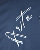 Coastal blue cotton T-shirt with close-up white embroidered script detail