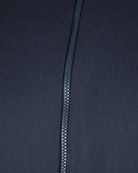 Navy front zipper close-up with metal pull and stitched placket.