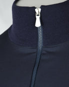 Navy stand collar with zipper pull on hybrid jacket, wool-front style.
