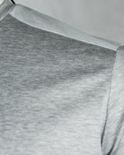 Light grey T-shirt shoulder and sleeve seam detail, crew neckline rib.