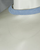 Crew neck ribbing close-up on pale lemon white T-shirt with light blue collar