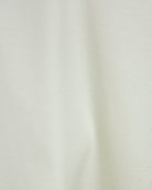 Pale lemon white cotton interlock T-shirt fabric close-up with smooth texture