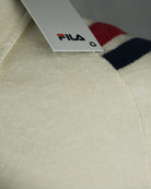 Cream terry polo hem label with FILA logo and navy red stripe trim