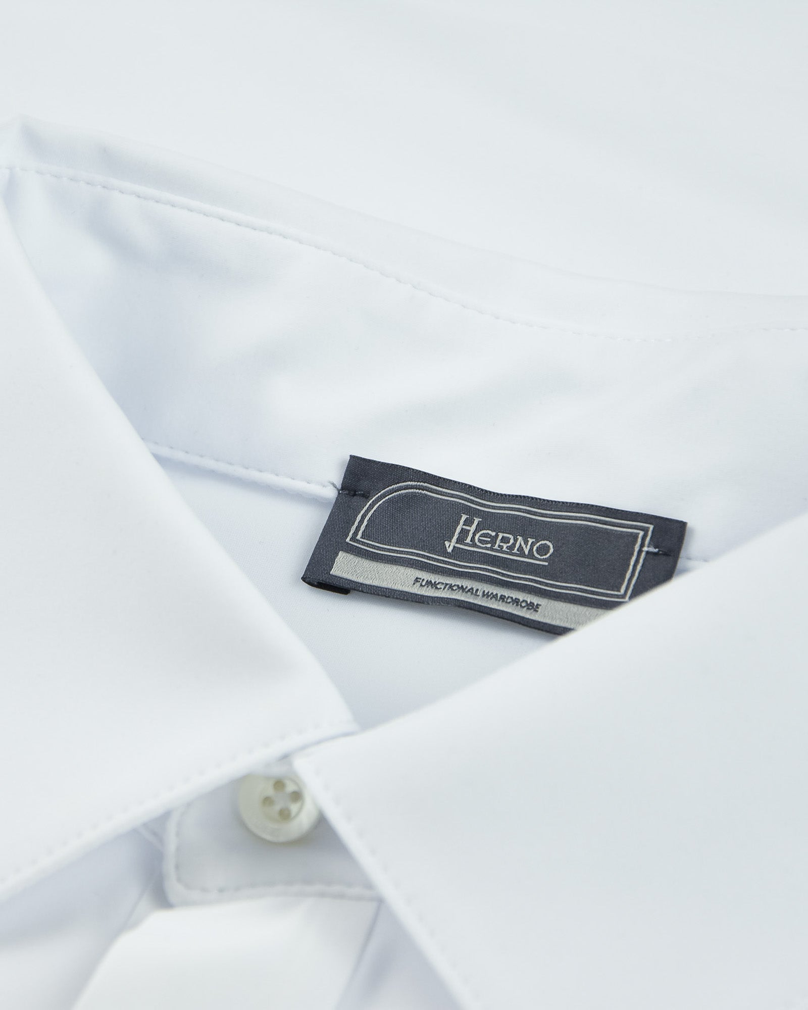 White polo shirt with Herno brand label on the inside neckline