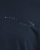 Close-up of navy T-shirt graphic with frequency bars and Corneliani text