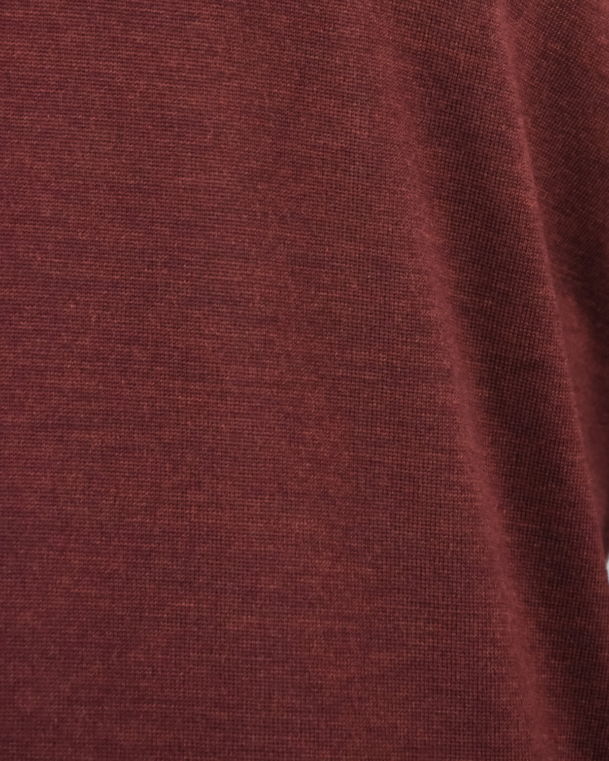 Burgundy knitted fabric swatch with fine textured knit