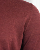 Burgundy knit sleeve with subtle shoulder seam and fine texture