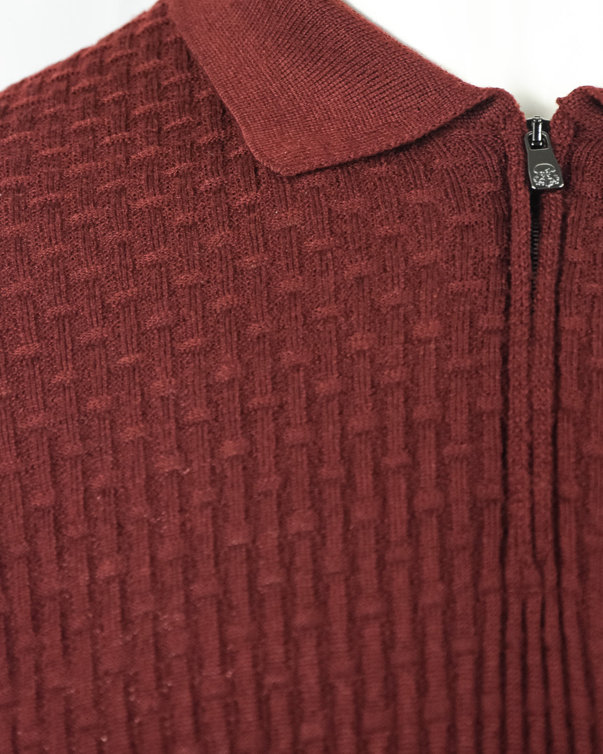 Burgundy textured knit polo with ribbed collar and zip placket