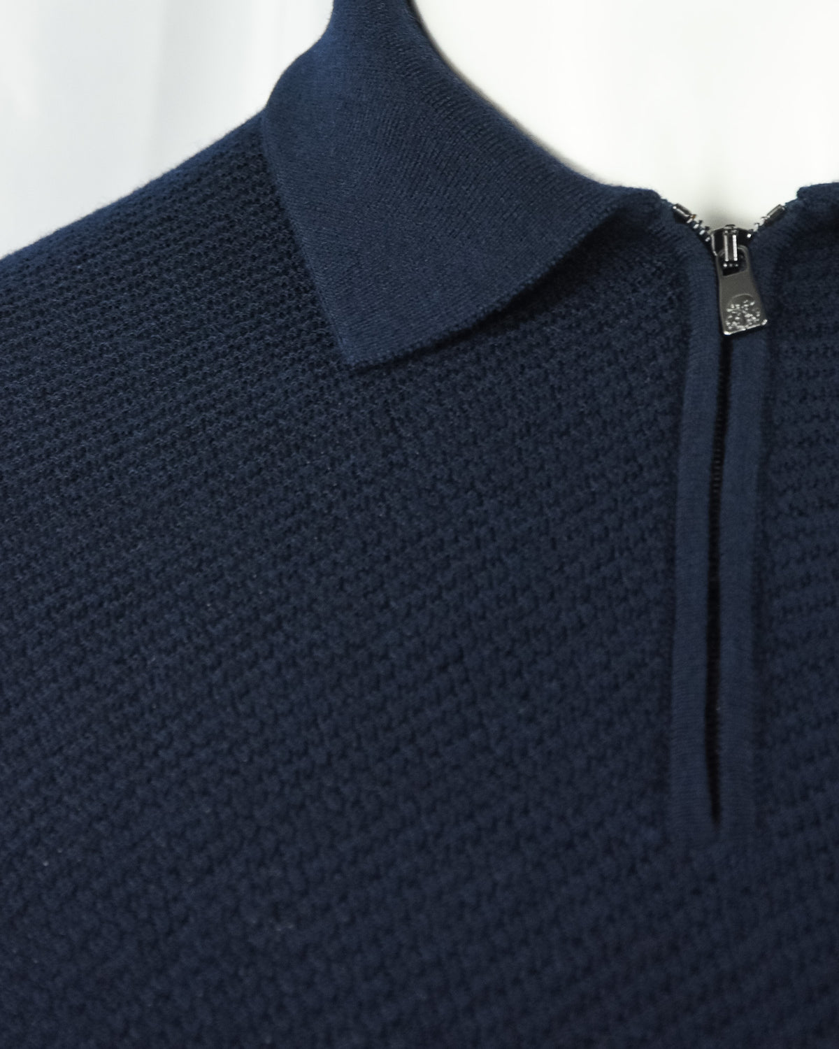 Navy textured knit polo shoulder and stand collar with zipper closure