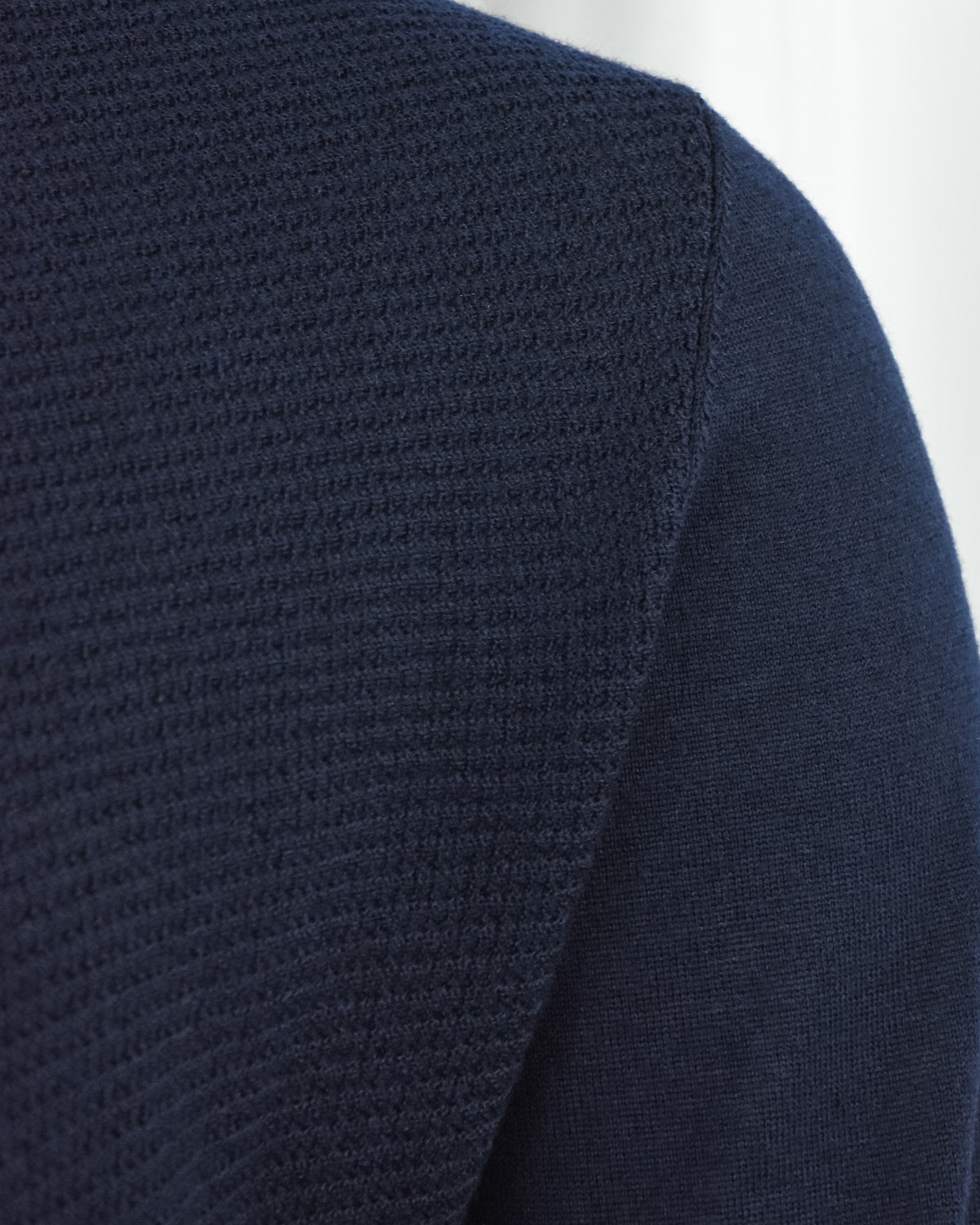 Navy long-sleeve knit polo with textured panel and solid cuff