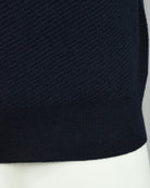 Navy knit polo hem with ribbed band and textured body