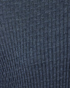 Blue textured knit fabric close-up with grid weave pattern