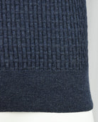 Blue ribbed knit hem cuff detail on long-sleeve polo