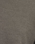 Taupe textured knit polo fabric close-up