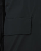 Black parka flap pocket close-up with straight stitched border