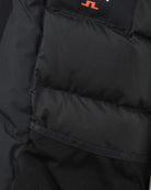 Black down parka interior with quilted lining and mesh inner pocket