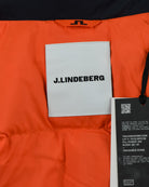Orange interior lining with J.Lindeberg garment tag and black barcode label