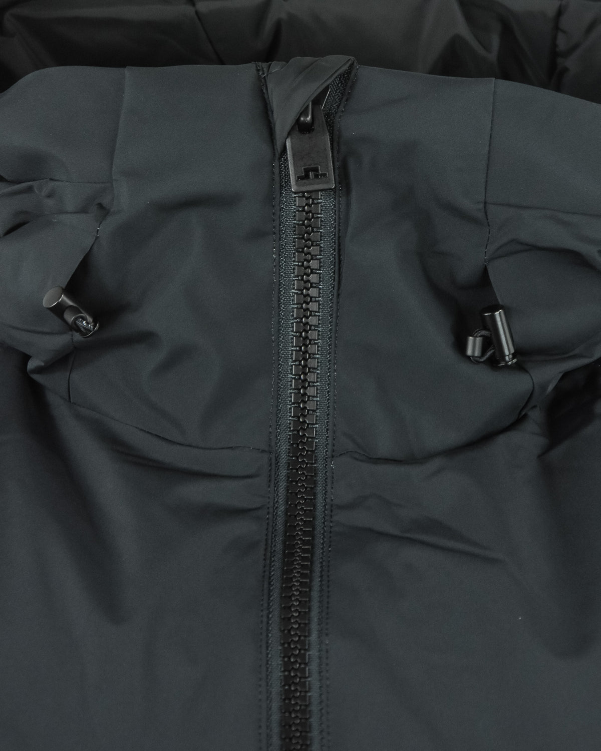 Down jacket midsection with exposed zipper and adjustable strap tabs