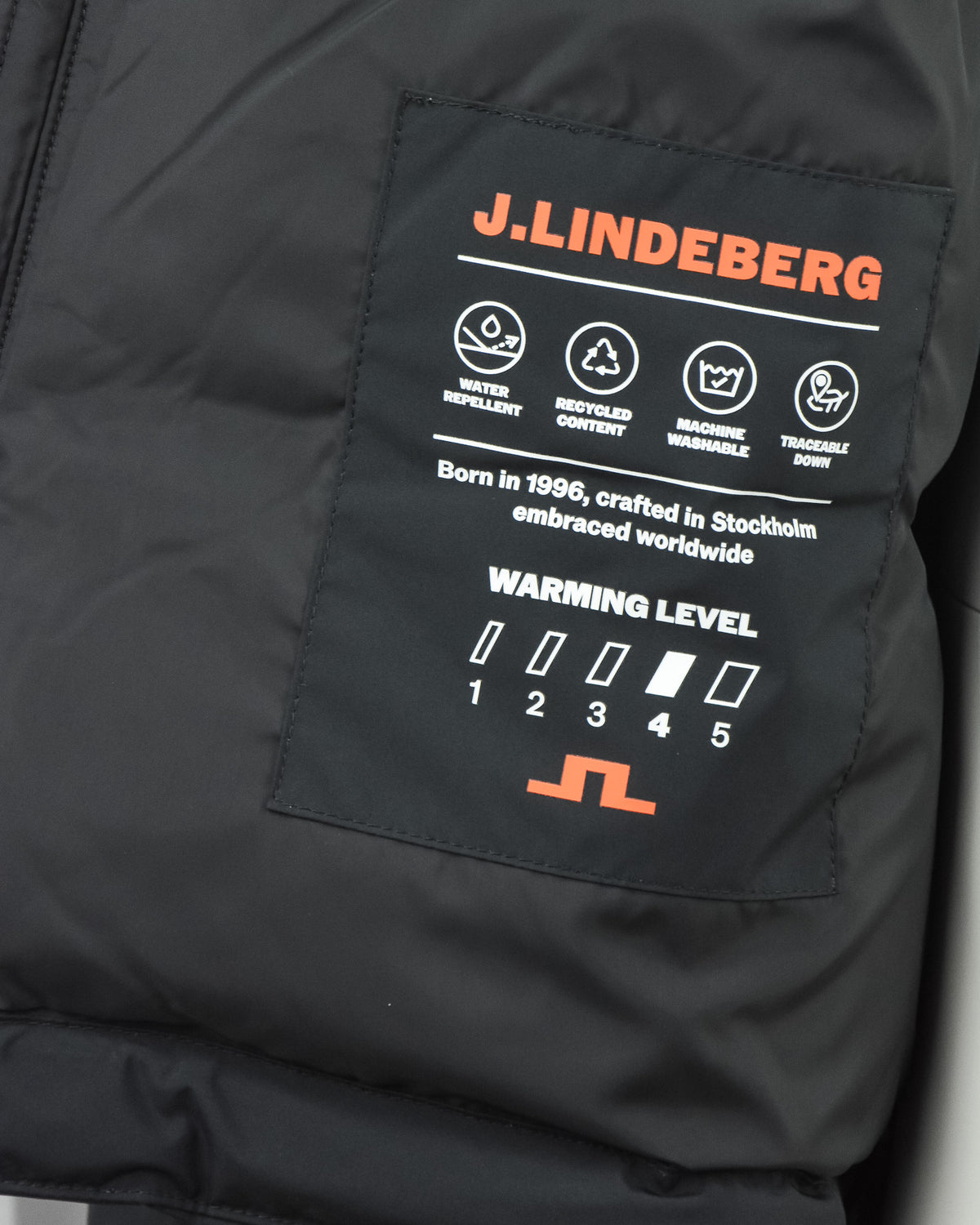 J.Lindeberg label on black down jacket lining with warmth level graphic