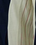 Cream sleeve panel with red pinstripe and navy side panel