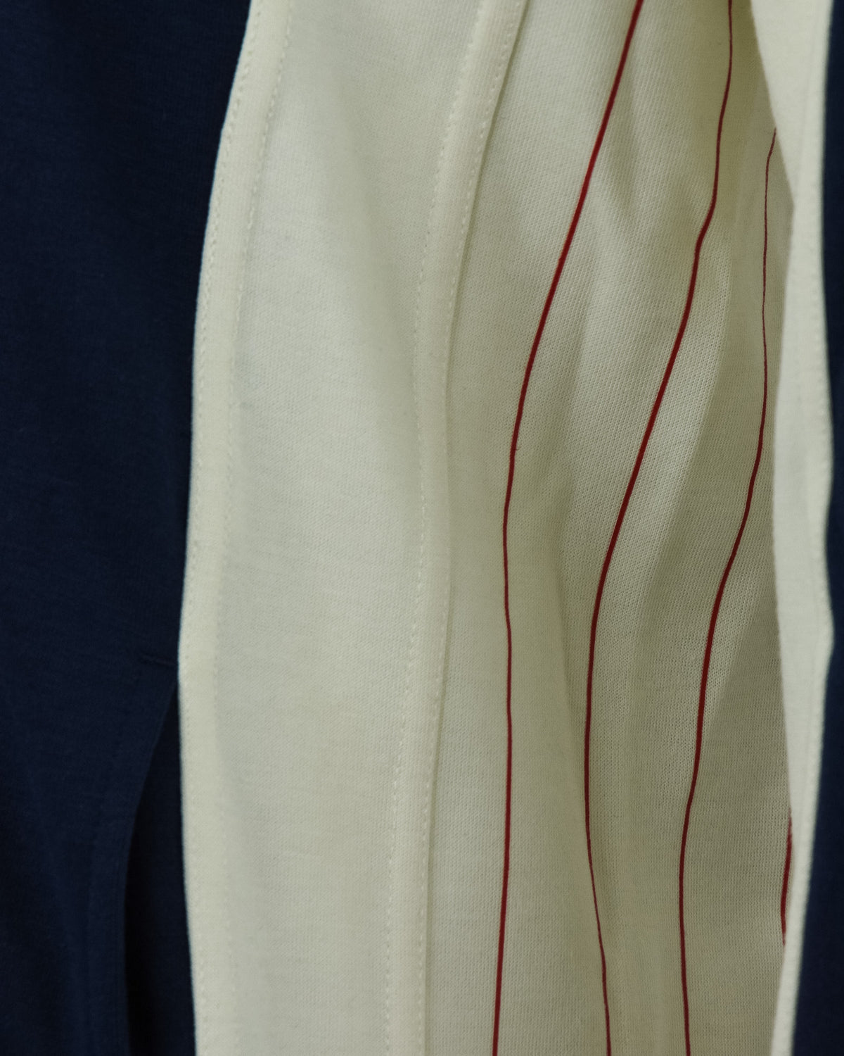 Cream sleeve panel with red pinstripe and navy side panel