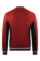 Back view red track jacket with black panels, striped rib hem, full-length zipper.